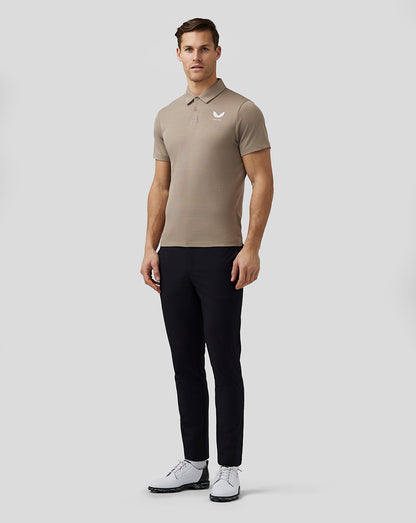 Front view of beige Pinnacle Knit Polo on a man with a small white Castore logo on the left chest