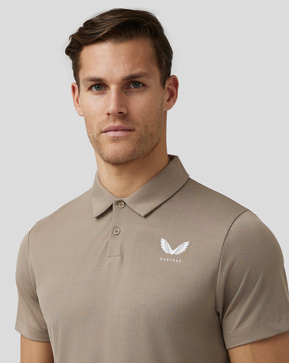 Beige Pinnacle Knit Polo worn by a model showing front view with Castore logo on the chest