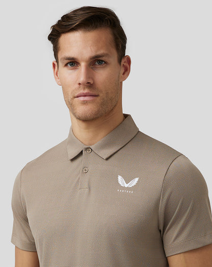 Beige Pinnacle Knit Polo worn by a model showing front view with Castore logo on the chest
