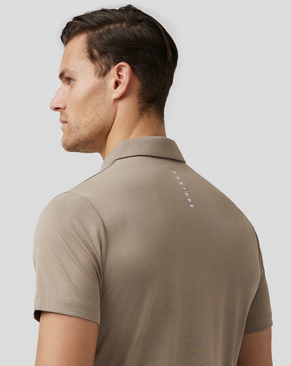 Back view of beige Pinnacle Knit Polo with Aertek branding at lower back and Castore logo at upper back
