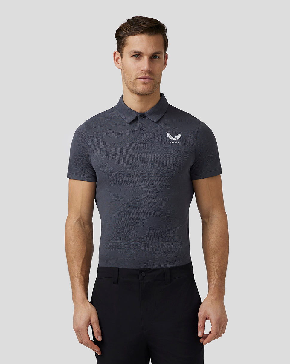 Pewter Pinnacle Knit Polo with short sleeves three-button placket and Castore logo on chest worn by male model.