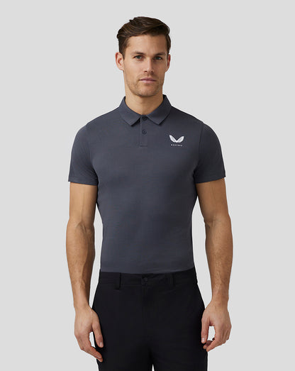 Pewter Pinnacle Knit Polo with short sleeves three-button placket and Castore logo on chest worn by male model.