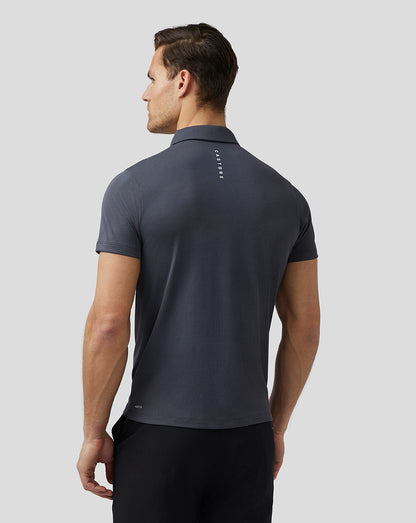 Back view of a man wearing a dark pewter Pinnacle Knit Polo with Castore branding along the upper back