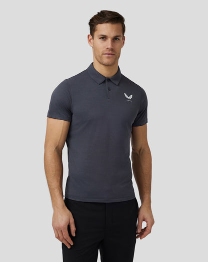 Front view of a male model in a pewter Pinnacle Knit Polo showing the polo collar and left chest logo