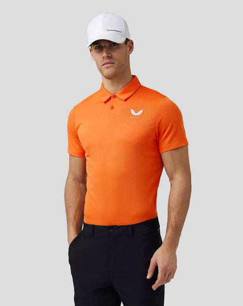 Man in bright orange knit golf polo with three-button placket and Castore logo on left chest
