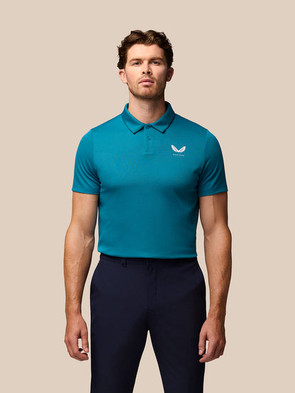 Male model wearing teal Pinnacle golf polo with three-button collar and Castore logo on chest