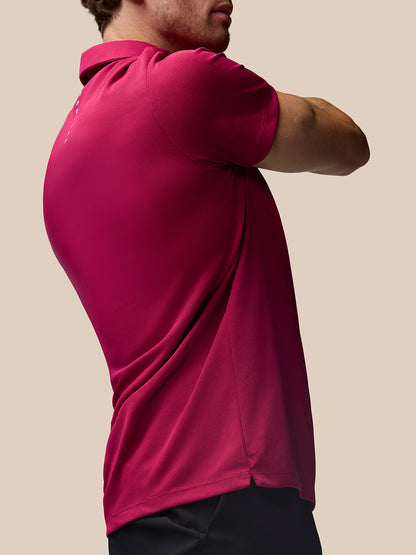 Back view of a man in a pink Pinnacle Golf Polo showing Castore branding running vertically along the back.