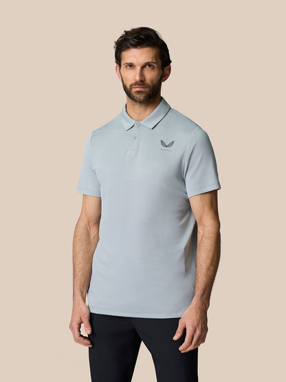 Male model wearing light grey Golf Pinnacle Polo with breathable knit texture and pointed collar.