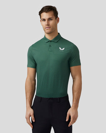Male model in green printed golf polo with hexagonal pattern and Castore logo on left chest.