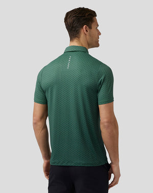 Back view of a man wearing green hex pattern golf polo with a stand collar and Castore branding on the upper back.