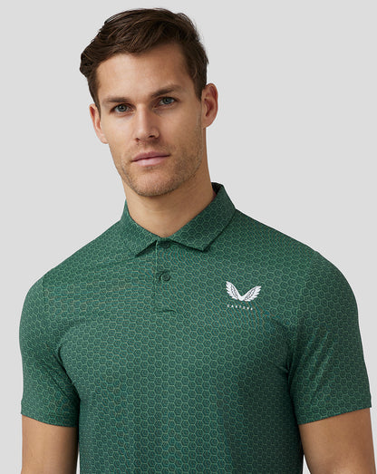 Male model wearing green hex pattern golf polo with Castore logo on left chest