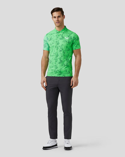 Front view of a male model wearing lime geometric printed polo with short sleeves and a chest logo