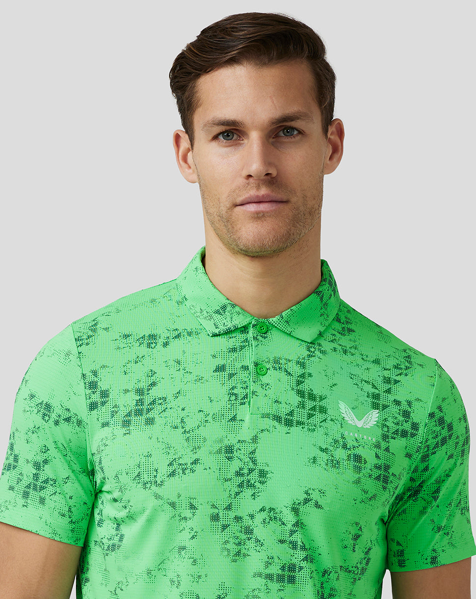 Male model wearing lime geo printed golf polo with short sleeves and Castore logo on chest