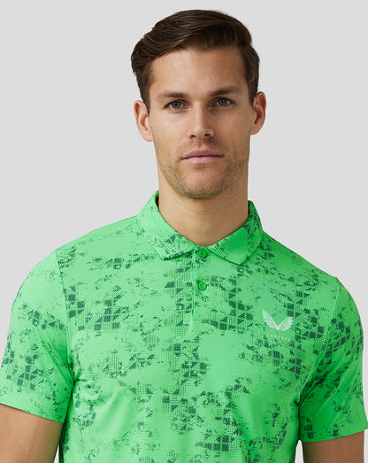 Male model wearing lime geo printed golf polo with short sleeves and Castore logo on chest
