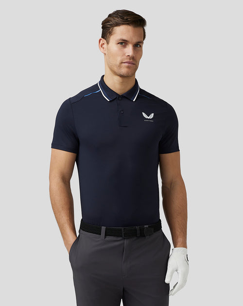 Front view of a man in a navy golf tech polo with white piping at the collar and Castore logo on the chest.