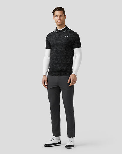 Front view of a man wearing a black pixel pattern golf polo with striped collar and white undershirt sleeves; Castore logo on left chest.