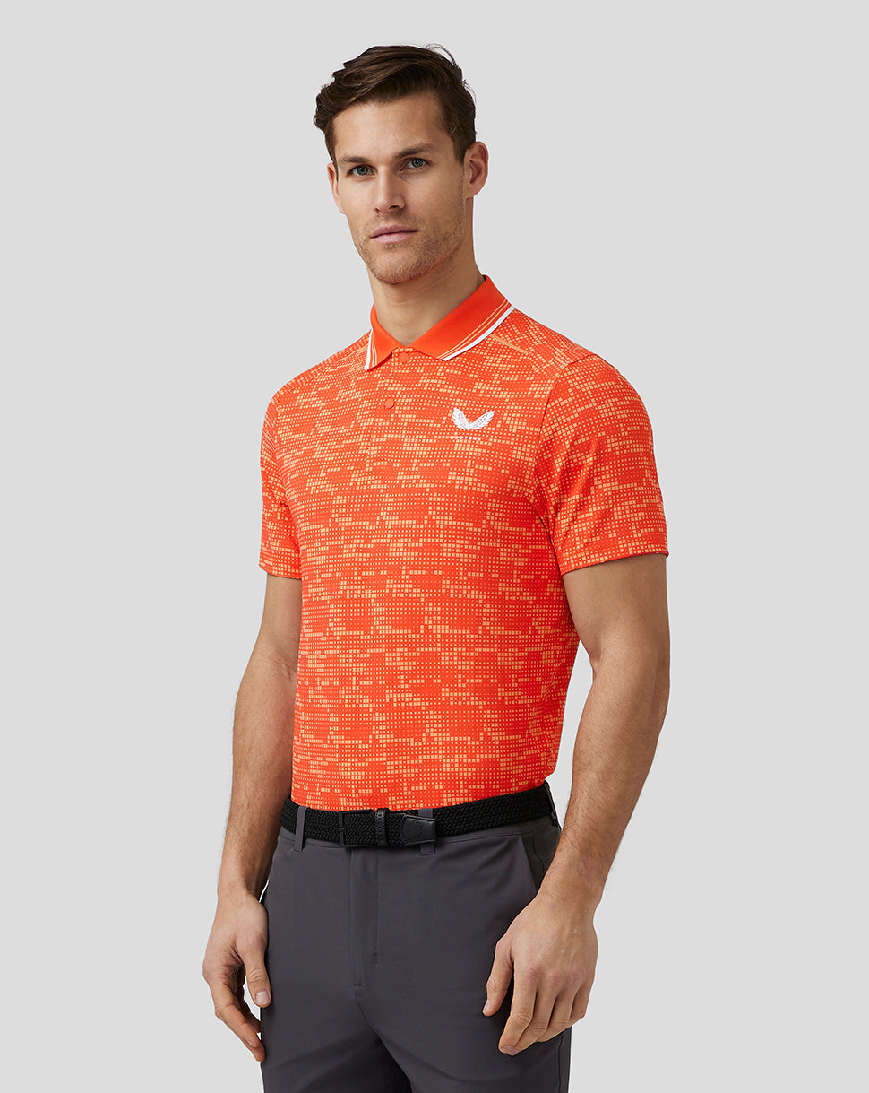 Male model in bright orange geo pattern golf polo with white collar trim