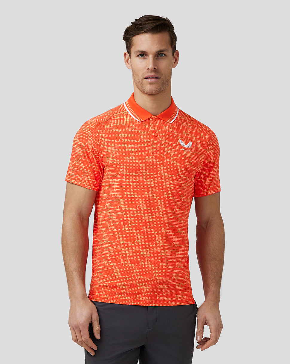 Front view of a male model in a bright orange printed golf polo with a white logo on the chest.