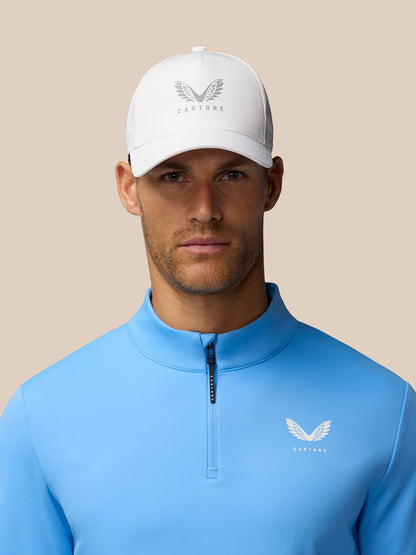 Side profile of a man in light blue Club Classic quarter zip top with Castore logo on the left chest.