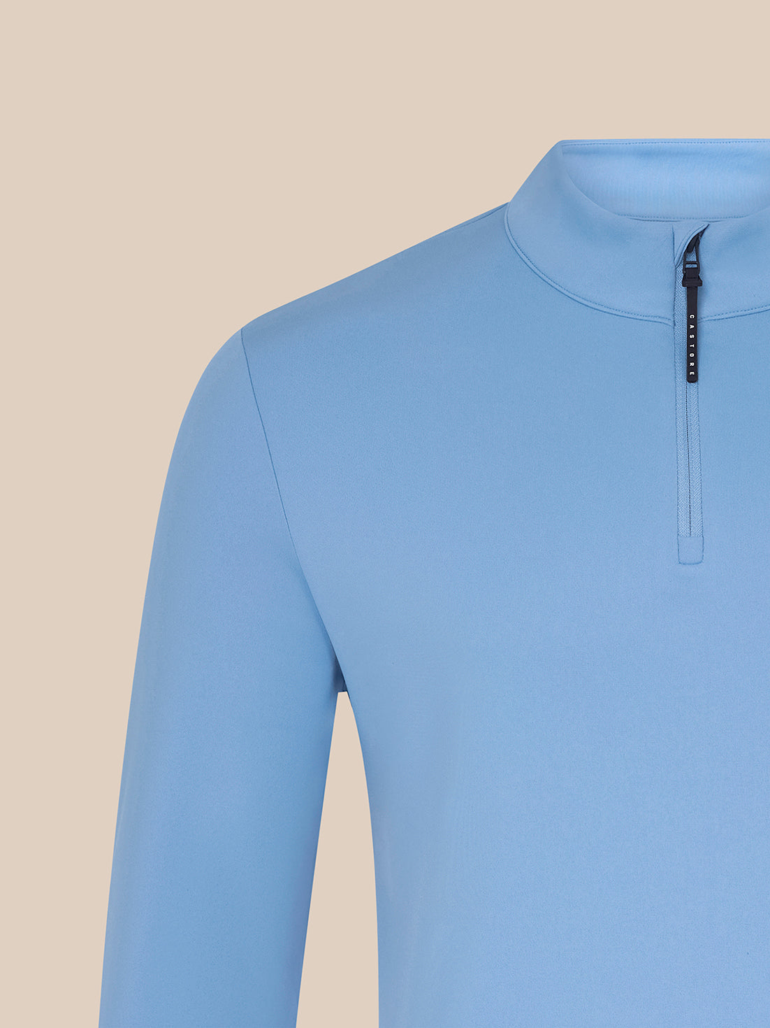 Close-up of sky blue Majesticks ¼ Zip Top chest area with Majesticks logo and Castore branded zipper pull.