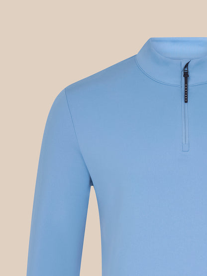 Close-up of sky blue Majesticks ¼ Zip Top chest area with Majesticks logo and Castore branded zipper pull.