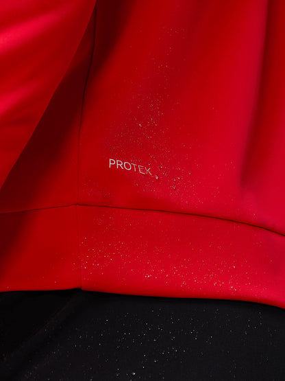 Close up of red Protek fabric with water droplets on the Castore Golf Club Classic top