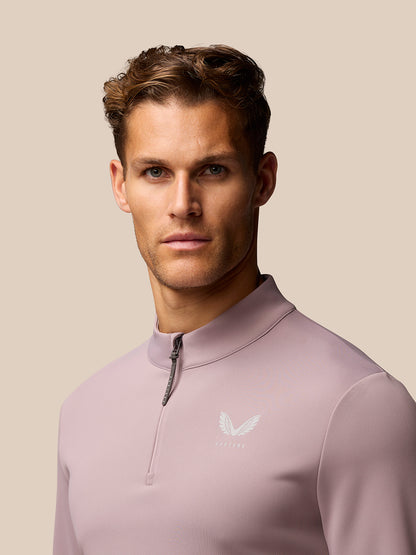 Male model wearing pink Club Golf 1/4 Zip Top with stand collar