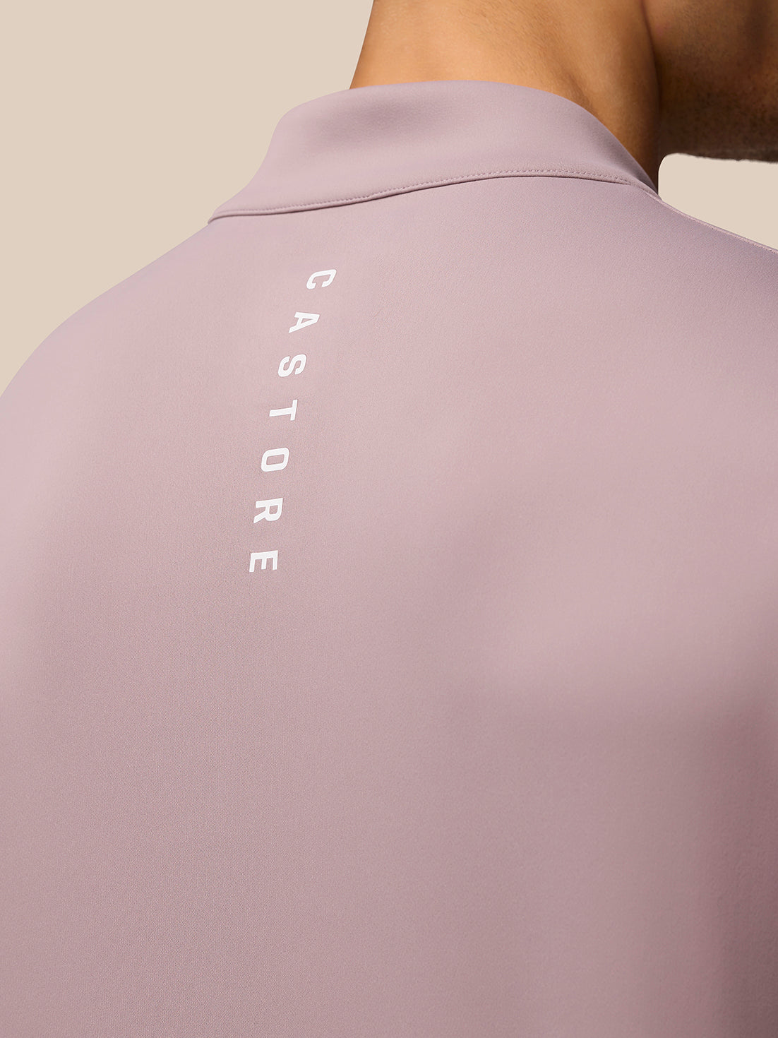 Back view of pink Club Golf 1/4 Zip Top showing vertical Castore branding along the back