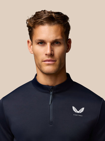 Male model wearing midnight navy Golf Club Classic quarter zip top with stand collar and front zipper