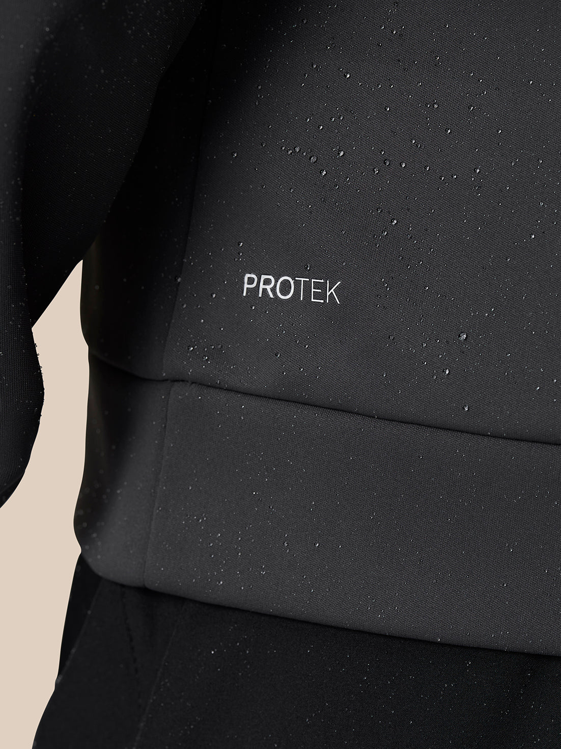 Close-up of dark Protek fabric with droplets showing water resistance.