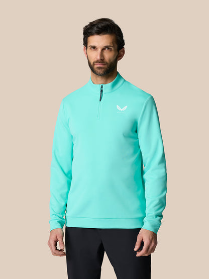 Male model wearing light aqua Golf Club Classic 1/4 Zip Top with stand collar and Castore logo on left chest
