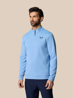 Male model wearing sky blue Golf Club Classic 1/4 Zip Top with stand collar long sleeves and left chest logo.