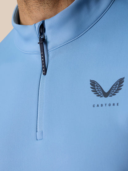 Close-up of sky blue Golf Club Classic 1/4 Zip top showing front zipper and Castore branding on chest
