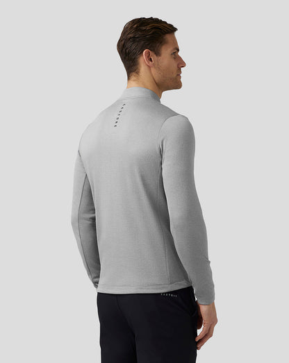 Back view of a man wearing steel Pinnacle Tech Half Zip Top with stand collar and Castore branding on the upper back
