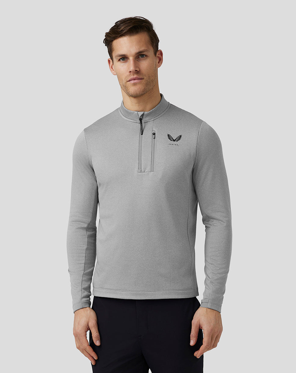 Front view of a man in steel Pinnacle Tech Half Zip Top with stand collar and left chest logo