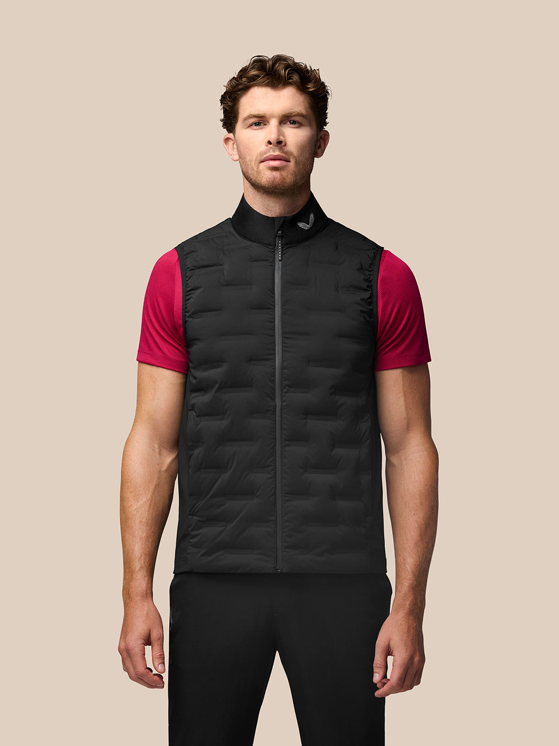 Male model wearing a black Pinnacle Gilet with stand collar over a pink short sleeve shirt