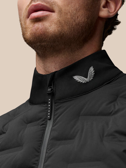 Close-up of a man wearing a black Golf Pinnacle Gilet with stand collar and logo at the collar