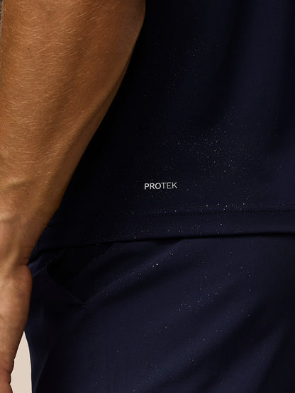 Close-up of navy fabric showing PROTEK label and water resistant texture.