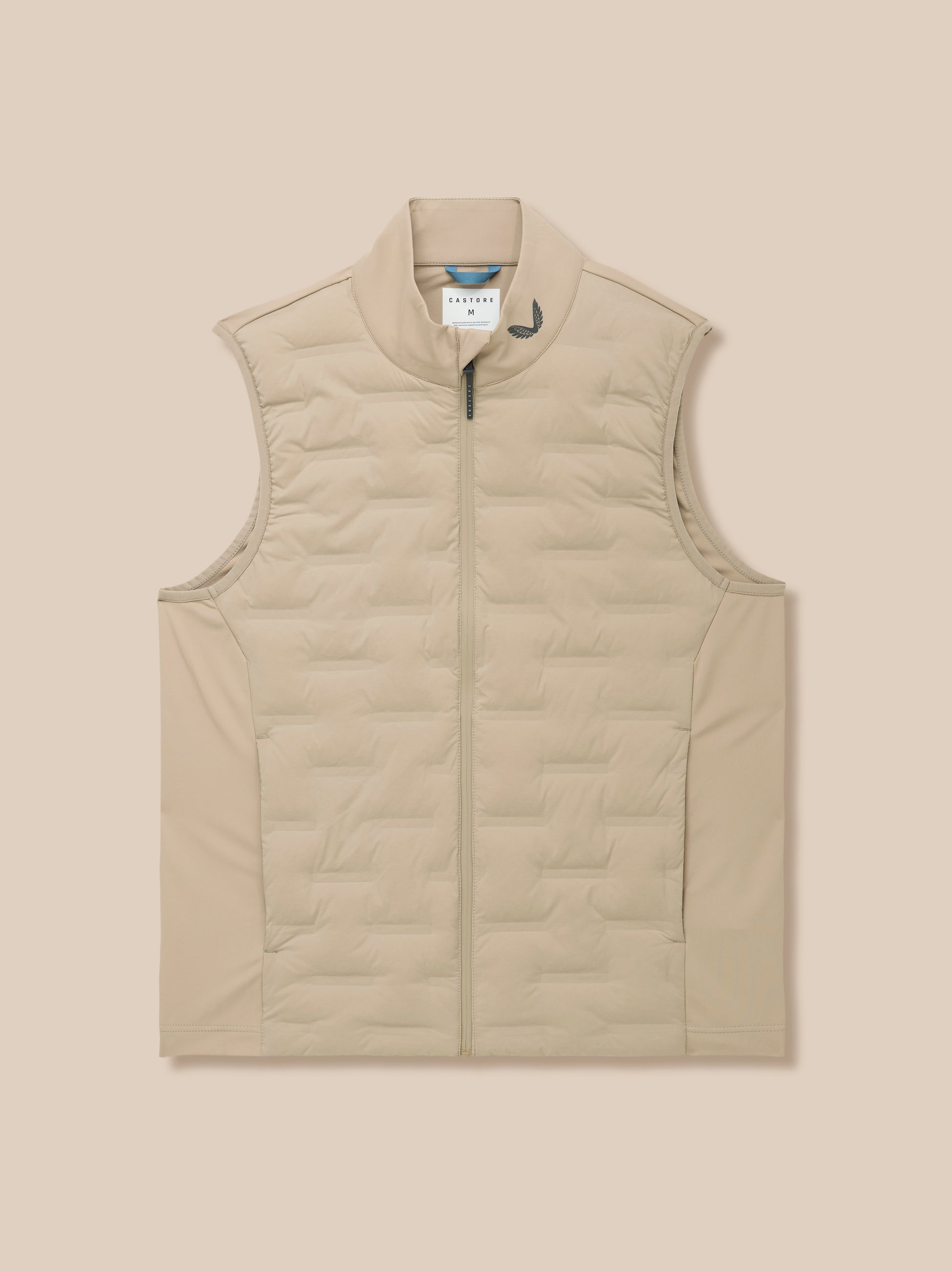 Beige Pinnacle Gilet upper torso with quilted panels and Castore emblem near the collar.