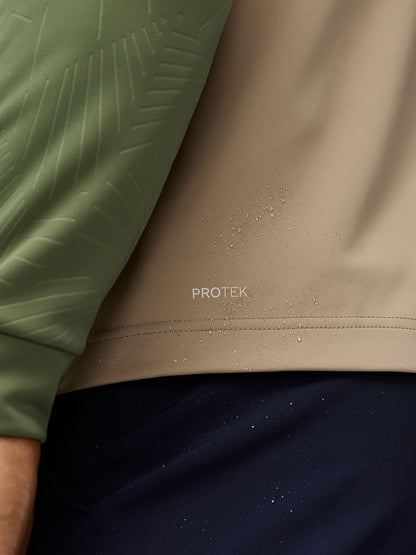 Close up of ProTek water resistant fabric with droplets on a beige Pinnacle Gilet.
