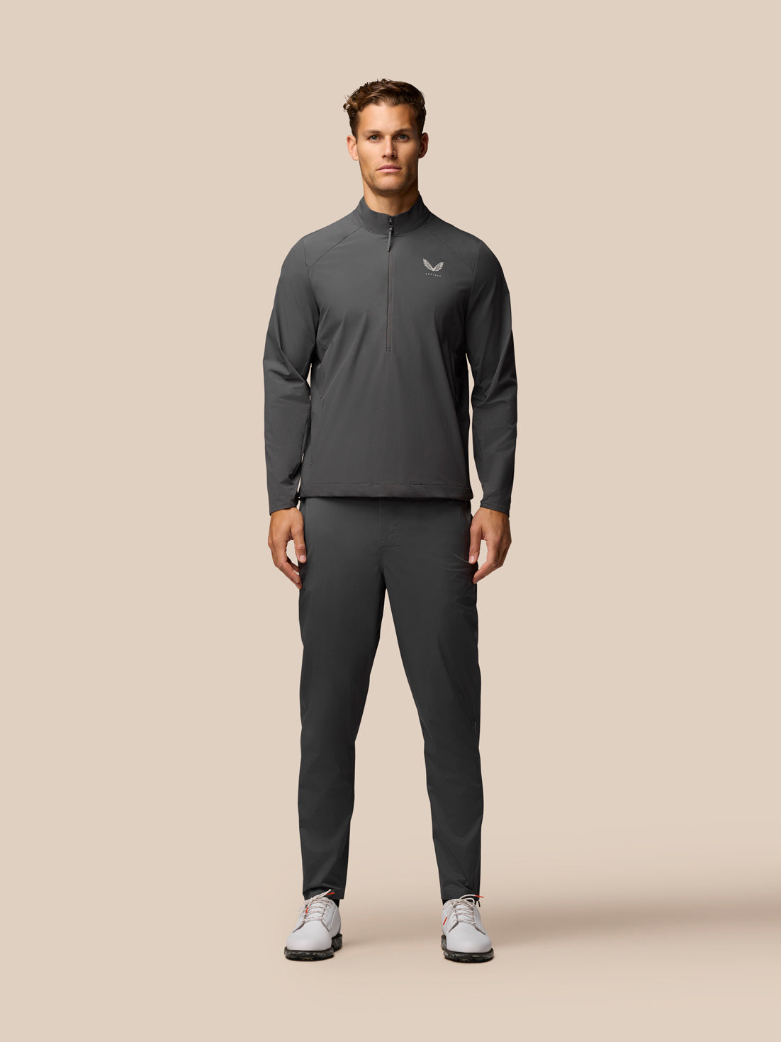 Male model in gunmetal golf lightweight waterproof over trousers set front view