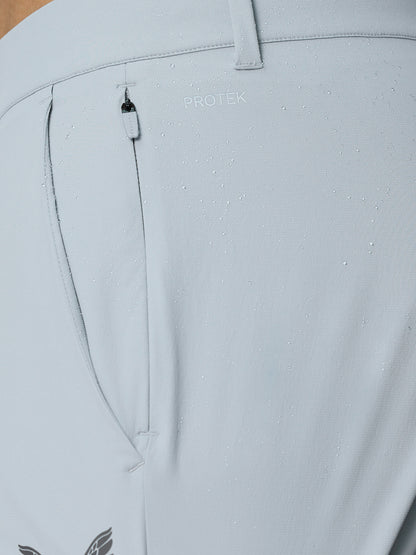 Close-up of the lower leg with cuff zip closure on light grey Golf Pinnacle Trousers showing water resistant fabric detail