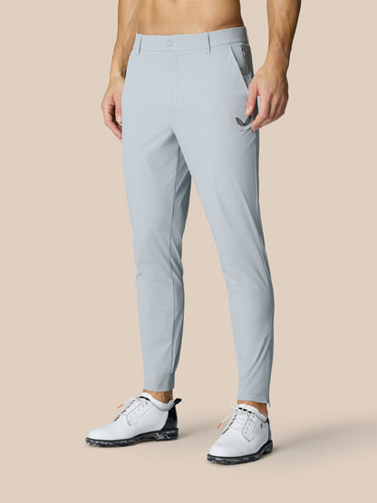 Back view of a male model wearing Golf Pinnacle Trousers 32 inch leg in mid grey with tapered cuffs.