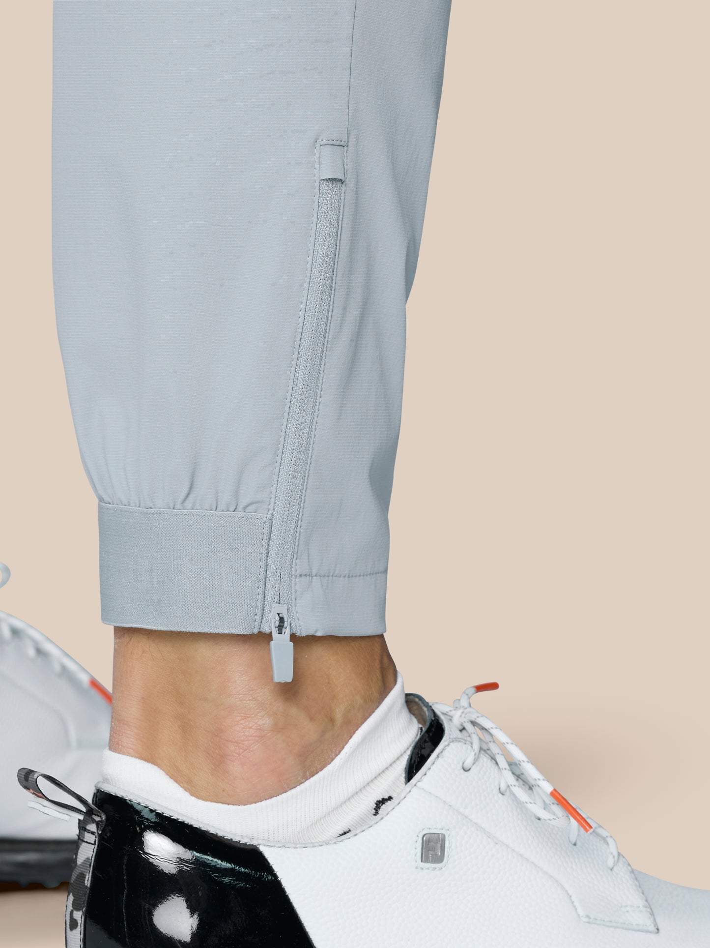 Close-up of trouser cuff with zipper and fabric texture in light grey Golf Pinnacle Trousers