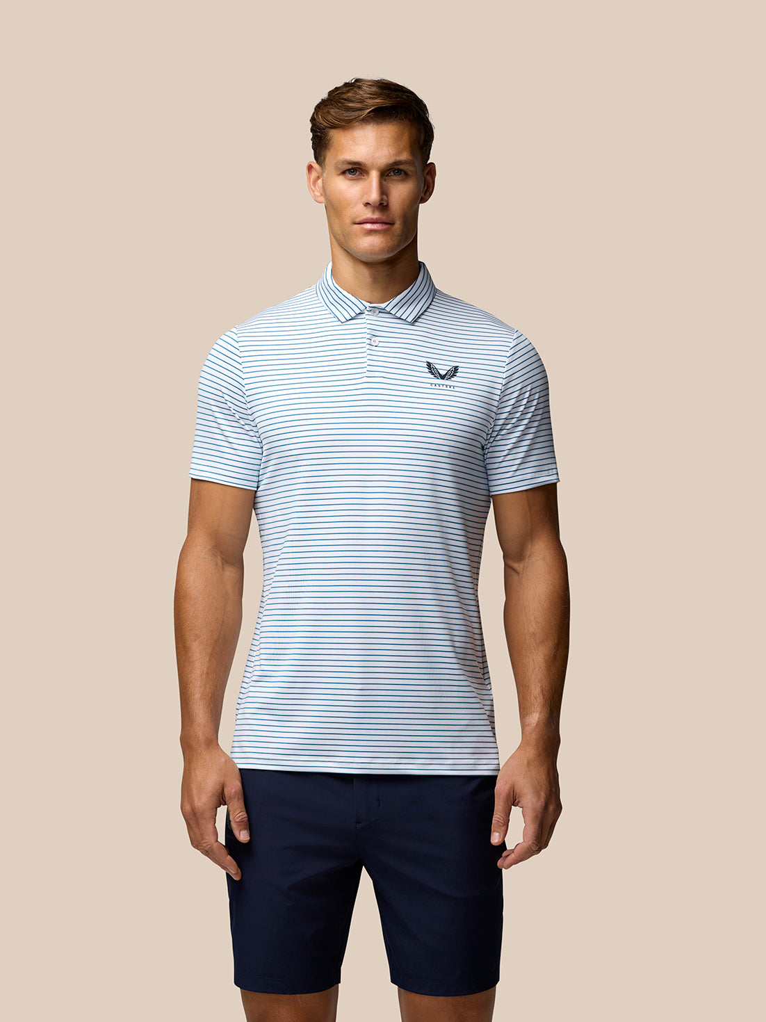 Model wearing white and blue striped Club Golf Polo seen from behind with Castore branding on upper back and Aertek branding on lower back