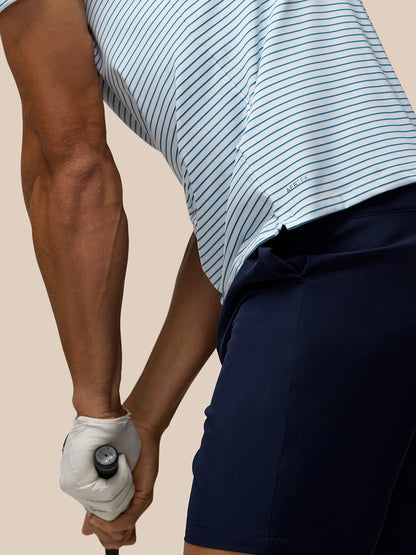 Side view of the striped polo with Aertek branding at the lower back hem.