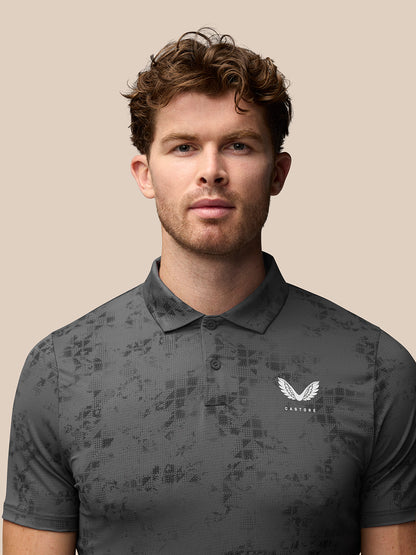 Detail shot of back of charcoal geo print polo showing vertical Castore branding