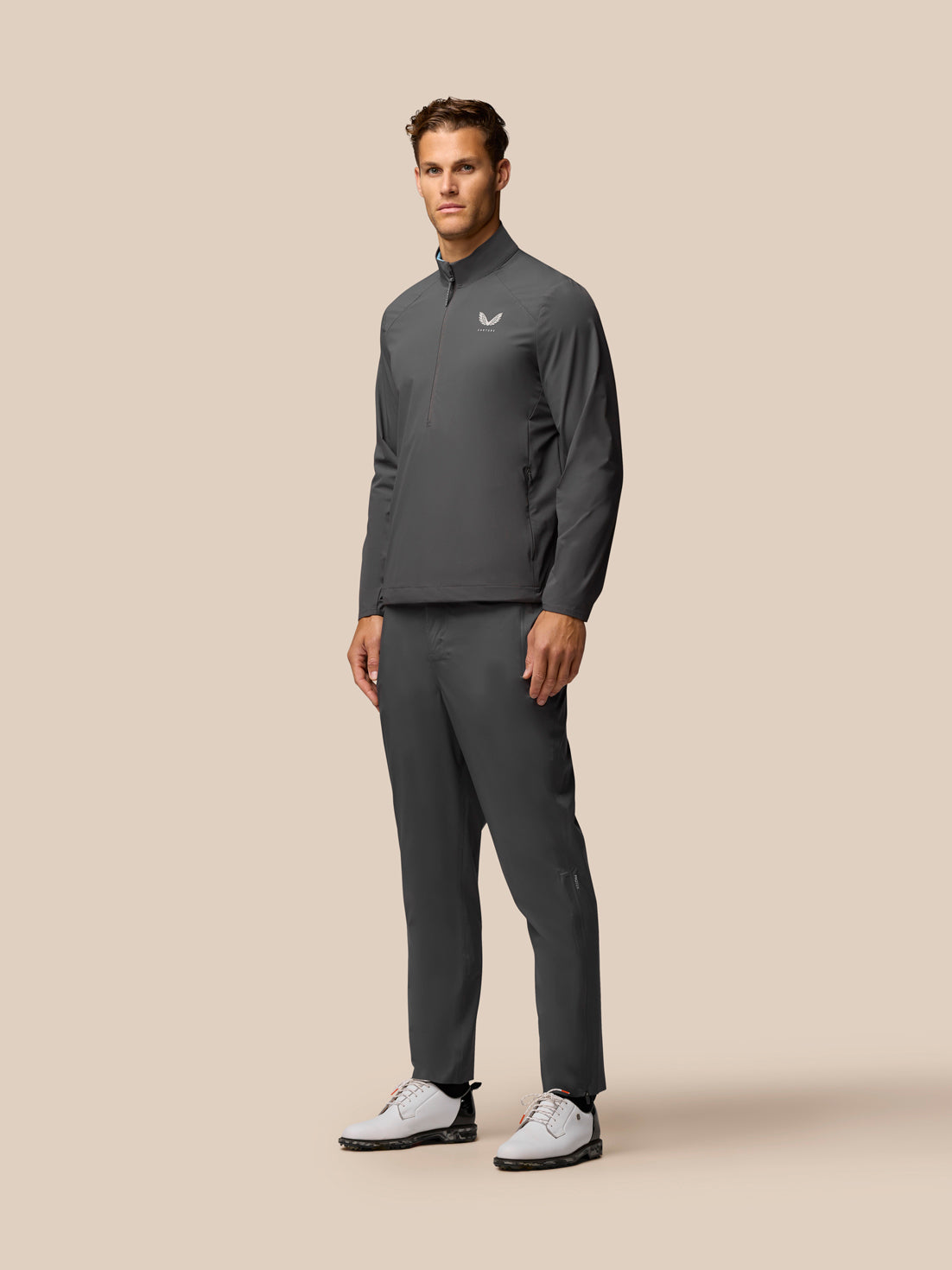 Back view of charcoal Golf Half Zip Top with center back seam and CASTORE branding at lower back