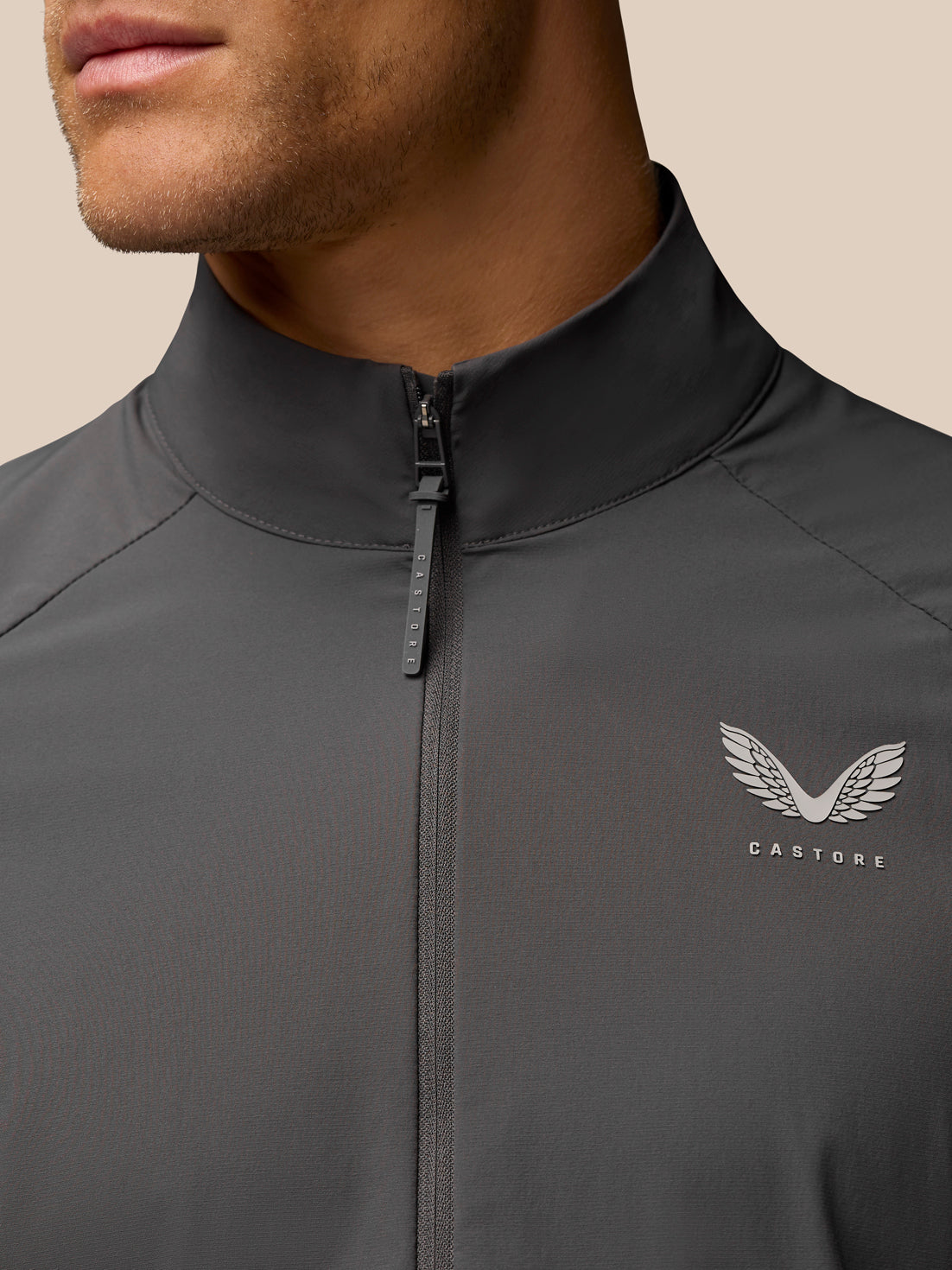 Close-up of charcoal Castore Golf Half Zip Top showing stand collar and front zip.