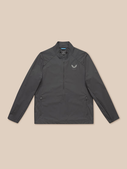 Model wearing charcoal Golf Half Zip Top with stand collar and chest logo.